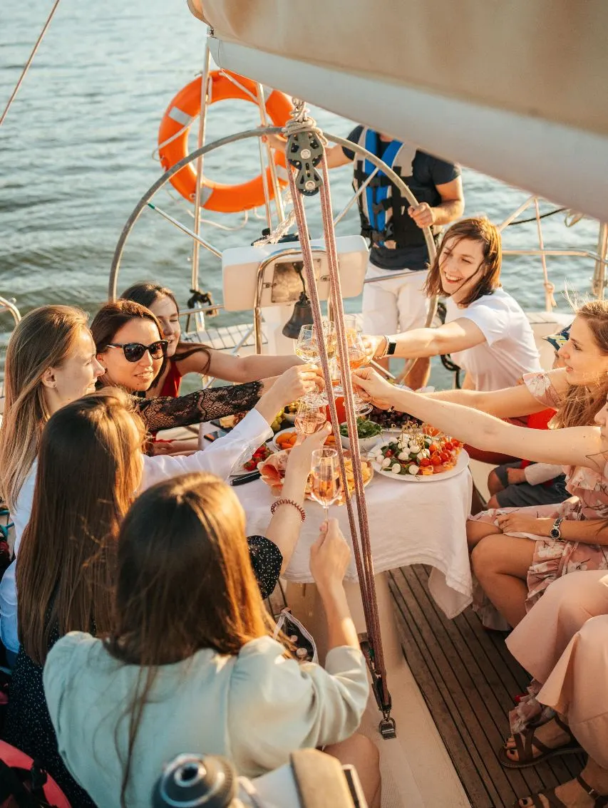 a group of foreigner ladies and a man having dinner on a boat