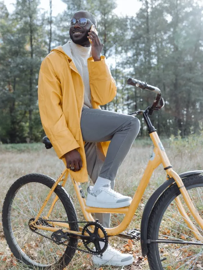 a man makiing a call on his bicycle