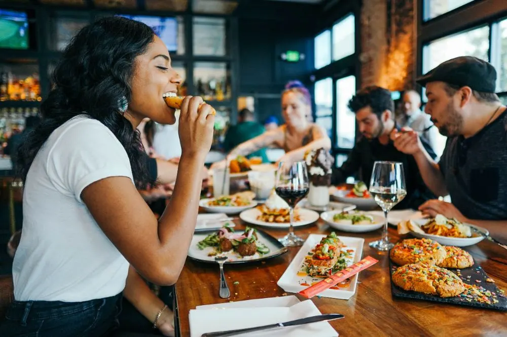 a lady and two guys having lunch together