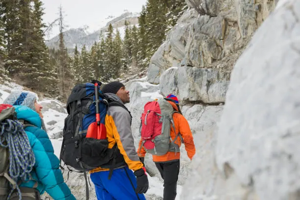 three foreiners hiking in the snow