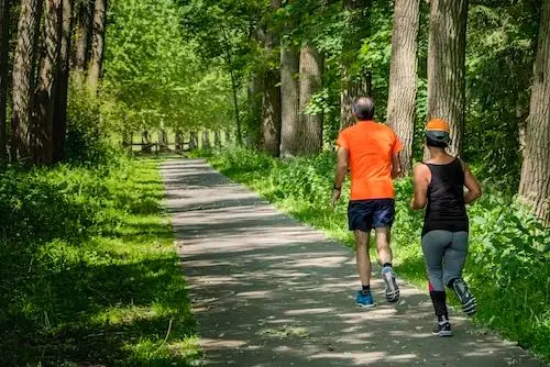 an old man and an old lady jogging