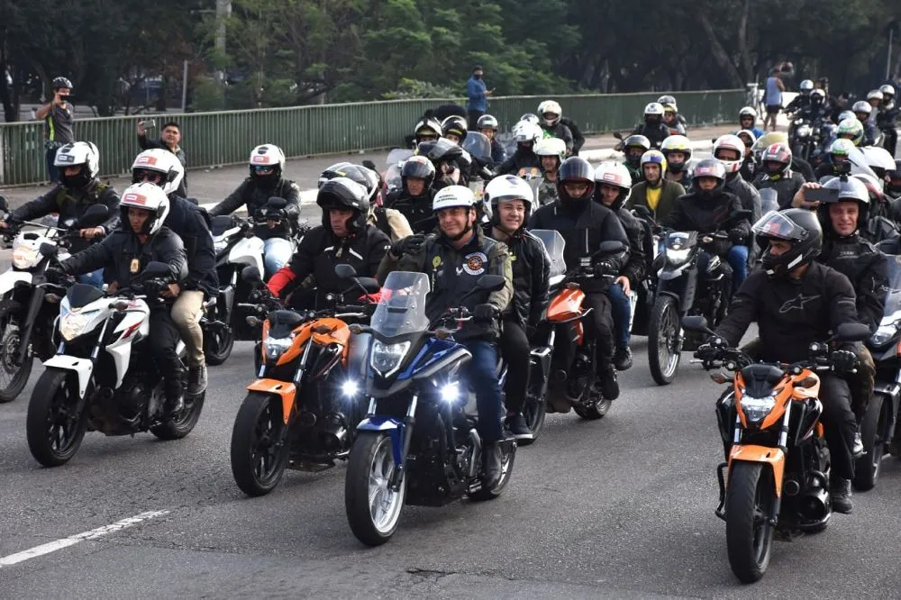 a group of motor riders riding together on the street