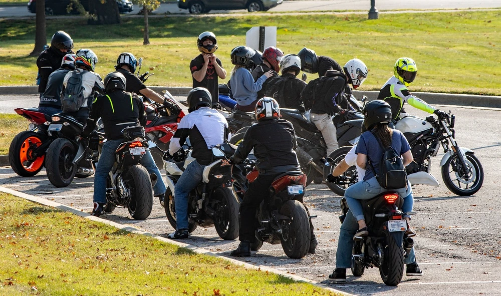 a group of motorcycle riders preparing for a town ride