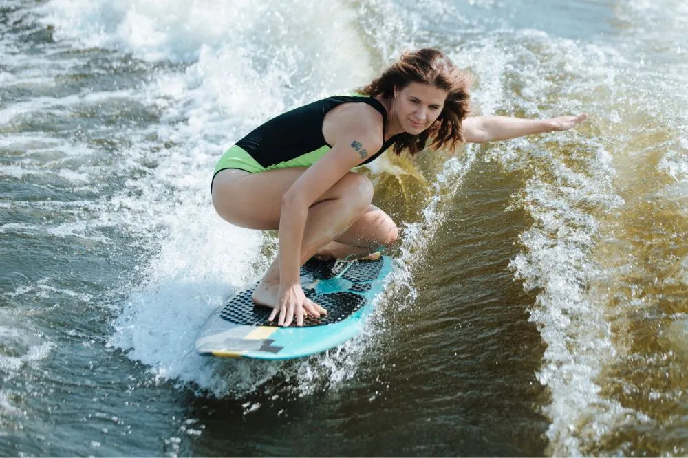 a lady foreiner surfing on the sea